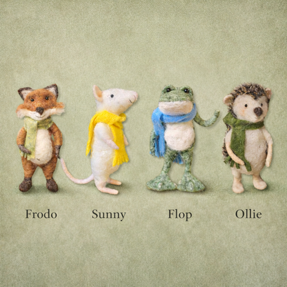 Fourneedle felted animals with scarves labeled Frodo, Sunny, Flop, and Ollie on a textured green background.
